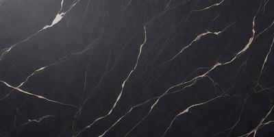 The primary subject of the image is a black marble countertop. The setting is a kitchen, with the countertop being the main focus of the scene. The visual style is a close-up of the marble countertop, showcasing its texture and pattern. The colors and mood of the image are dark and moody, with the black marble countertop being the dominant color.