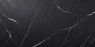 The primary subject of the image is a black marble countertop. The setting is a kitchen, with the countertop being the main focus of the scene. The visual style is a close-up of the marble countertop, showcasing its texture and details. The colors and mood of the image are dark and moody, with the black marble countertop being the dominant color.