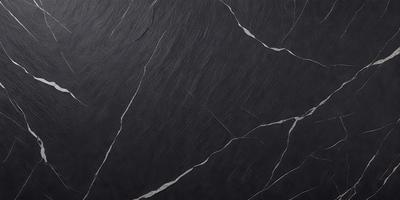 The primary subject of the image is a black marble countertop. The setting is a kitchen, with the countertop being the main focus of the scene. The visual style is a close-up of the marble countertop, showcasing its texture and details. The colors and mood of the image are dark and moody, with the black marble countertop being the dominant color.