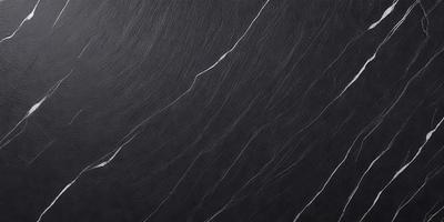 The primary subject of the image is a black marble countertop. The setting is a kitchen, with the countertop being the main focus of the scene. The visual style is a close-up of the marble countertop, showcasing its texture and pattern. The colors and mood of the image are predominantly dark, with the black marble countertop being the main source of contrast.
