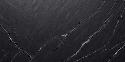 The primary subject of the image is a black marble countertop. The setting is a dark room, and the visual style is a close-up of the marble countertop. The countertop appears to be a dark grey color, giving it a sophisticated and elegant appearance.