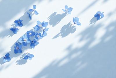 The primary subject of the image is a group of blue flowers, which are the main objects in the scene. The flowers are arranged in a visually appealing manner, creating a sense of harmony and beauty. The setting is a white background, which provides a clean and minimalist backdrop for the flowers. The visual style of the image is a combination of photo and digital art, as it captures the natural beauty of the flowers while also showcasing the artist's creativity and skill in arranging the flowers. The colors and
