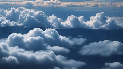 The primary subject of the image is a cloudy sky filled with various cloud formations. The setting is a vast, open space with no visible landmarks or objects. The visual style is a natural, outdoor scene with a focus on the clouds. The colors and mood of the image are predominantly blue and white, creating a serene and peaceful atmosphere.