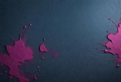 The primary subject of the image is a pink paint splatter on a blue surface. The setting is a dark room, and the visual style appears to be a photo. The dominant colors are pink and blue, creating a contrasting and visually striking scene.
