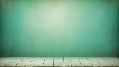 The primary subject of the image is a green wall with a wooden floor. The setting is a room with a green wall, and the visual style is a photo. The dominant colors are green and white, creating a calm and serene atmosphere.