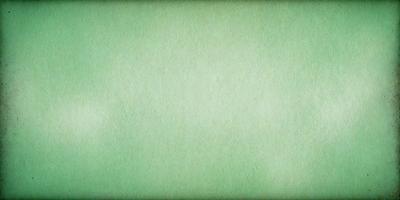 The primary subject of the image is a large, green, textured surface. The setting is a green background, which creates a calm and serene atmosphere. The visual style is a close-up of the green surface, showcasing its texture and color. The colors and mood of the image are predominantly green, giving it a natural and soothing appearance.