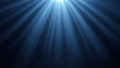 The primary subject of the image is a bright light source, possibly a sun or a light bulb, shining through a blue sky. The setting is a dark, star-filled sky, creating a contrasting backdrop for the light source. The visual style appears to be a digital art or illustration, as the light source is depicted in a stylized manner. The colors and mood of the image are predominantly blue and dark, with the bright light source adding a sense of warmth and energy to the scene.
