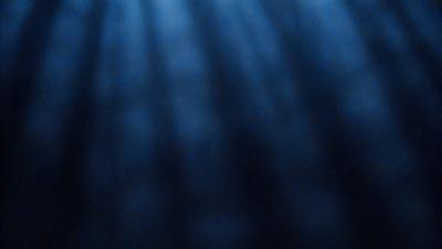 The primary subject of the image is a blue ocean with a few ripples. The setting is the ocean, and the visual style is a photo. The dominant colors are blue and white, creating a calm and serene atmosphere.