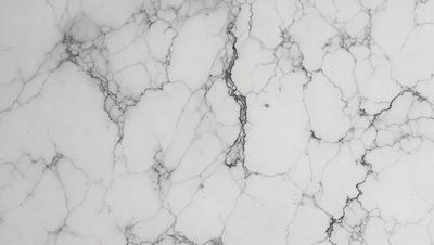 The primary subject of the image is a marble surface with a white background. The visual style is a photo, and the colors and mood are predominantly white, giving the scene a clean and elegant appearance.