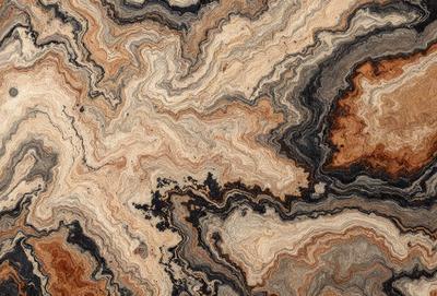 The primary subject of the image is a close-up of a marble-like stone with a unique and intricate pattern. The setting is a natural environment, possibly a rock formation or a stone surface. The visual style is a close-up of the stone, showcasing its texture and details. The colors and mood of the image are predominantly earthy tones, giving it a natural and organic feel.