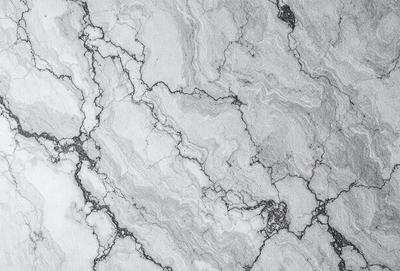 The image features a marble countertop with a patterned texture. The countertop appears to be made of marble, giving it a luxurious and elegant appearance. The pattern on the marble countertop adds visual interest and depth to the surface.