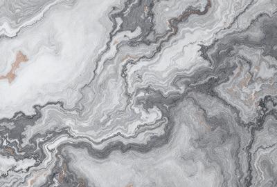 The primary subject of the image is a marble-like surface with a pattern of swirls and curves. The setting is a stone countertop, and the visual style is a close-up of the marble pattern. The colors and mood of the image are predominantly grays and browns, giving it a natural and earthy appearance.