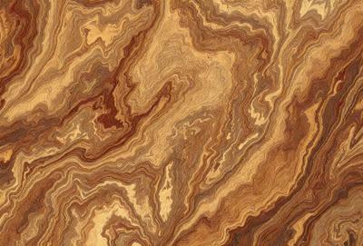 The primary subject of the image is a wooden surface with a unique and intricate pattern. The setting is a close-up view of the wooden surface, showcasing the detailed design. The visual style is a close-up of the wooden surface, which gives a sense of depth and texture. The colors and mood of the image are warm and earthy, with the wooden surface being the main focus.