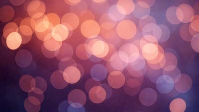 The primary subject of the image is a brightly colored, blurry background with a pattern of circles. The setting appears to be a nighttime scene, possibly a cityscape. The visual style of the image is a combination of a photo and digital art, creating a unique and vibrant atmosphere. The dominant colors in the image are pink and orange, giving the scene a warm and lively mood.
