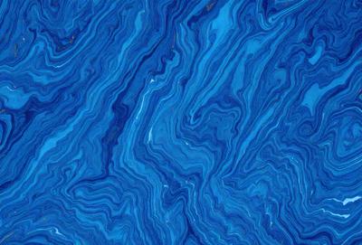 The primary subject of the image is a blue and white patterned surface, which appears to be a blue and white marble or a blue and white tile. The setting is a close-up of the pattern, showcasing the intricate design. The visual style is a close-up of the pattern, which gives a sense of depth and detail. The colors and mood of the image are predominantly blue and white, creating a calm and serene atmosphere.