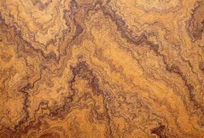 The primary subject of the image is a wooden surface with a unique and intricate pattern. The setting is a close-up view of the wooden surface, showcasing the detailed design. The visual style is a close-up of the wooden surface, which gives a sense of depth and texture. The colors and mood of the image are warm and earthy, with the wooden surface being the dominant color.
