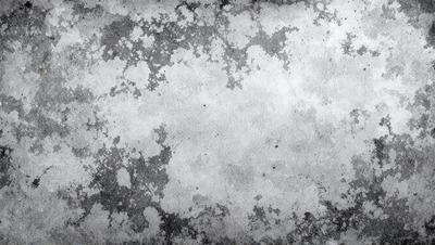 The primary subject of the image is a large, textured surface with a variety of patterns and textures. The setting appears to be a concrete wall or a similar textured surface. The visual style of the image is a combination of photo and digital art, creating a unique and intricate design. The dominant colors in the image are grays and browns, giving the scene a somewhat dull and aged appearance.