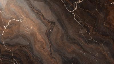 The image features a marble countertop with a brown and black color scheme. The countertop has a unique and intricate design, giving it a natural and elegant appearance. The setting is a kitchen or a similar environment where the countertop is used for food preparation or display. The visual style of the image is a close-up of the marble countertop, highlighting its texture and beauty. The colors and mood of the image are warm and inviting, creating a sense of luxury and sophistication.