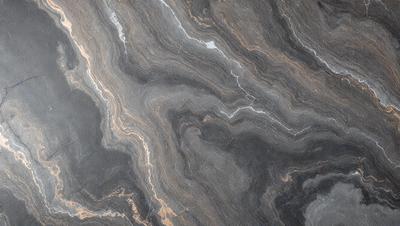 The image features a close-up of a marble countertop with a unique, swirling pattern. The countertop appears to be made of stone, and the pattern adds a sense of depth and texture to the surface. The overall atmosphere of the image is elegant and sophisticated, showcasing the beauty of the marble countertop.