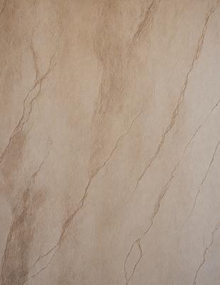 The image features a wall with a unique, textured surface. The wall appears to be made of a combination of stone and cement, giving it a distinctive appearance. The primary subject of the image is the wall, which serves as the main focus of the scene. The setting is indoors, likely in a room or a building. The visual style of the image is a close-up, allowing the viewer to appreciate the intricate details of the wall's texture. The colors and mood of the image are earthy