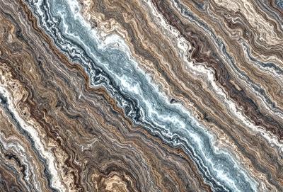 The primary subject of the image is a close-up of a marble stone with a unique and intricate pattern. The setting is a natural environment, with the stone being the main object of focus. The visual style is a close-up of the marble, showcasing its texture and details. The colors and mood of the image are predominantly earthy tones, giving it a natural and timeless appearance.