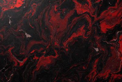 The primary subject of the image is a close-up of a red and black marbled surface. The setting is a dark room, and the visual style appears to be a photo. The dominant colors in the image are red and black, creating a bold and striking appearance.