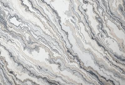 The primary subject of the image is a marble countertop with a unique and intricate pattern. The setting is a kitchen or bathroom, as the countertop is a prominent feature in the space. The visual style is a close-up of the marble countertop, showcasing its texture and design. The colors and mood of the image are predominantly neutral, with the marble countertop being the main focus and source of interest.