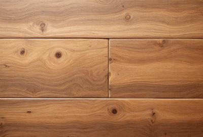 The primary subject of the image is a wooden floor with a unique and intricate pattern. The setting is a room with a wooden wall, which adds to the overall atmosphere. The visual style of the image is a close-up of the wooden floor, showcasing the details of the pattern. The colors and mood of the image are warm and natural, with the wooden floor and wall creating a cozy and inviting environment.