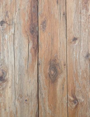 The primary subject of the image is a wooden floor with a unique and rustic appearance. The setting is a room with a wooden floor, and the visual style is a close-up of the wooden surface. The colors and mood of the image are predominantly brown and natural, giving it a warm and cozy atmosphere.