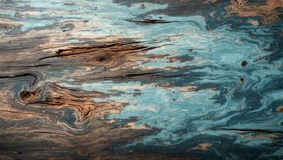 The primary subject of the image is a wooden surface with a blue tint. The setting is a wooden table, and the visual style is a photo. The dominant colors are blue and brown, creating a calm and natural atmosphere.