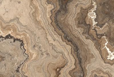 The primary subject of the image is a marble-like stone with a unique pattern. The setting is a stone wall, and the visual style appears to be a combination of a photo and digital art. The colors and mood of the image are predominantly brown and earthy, giving it a natural and textured appearance.