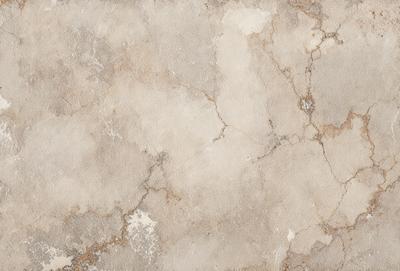 The primary subject of the image is a close-up of a white, textured wall. The setting is a room with a stone-like texture, giving it a unique and interesting appearance. The visual style is a close-up, which emphasizes the details of the wall's texture. The colors and mood of the image are predominantly white, giving it a clean and minimalist feel.