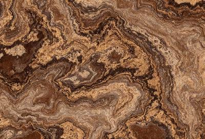 The primary subject of the image is a close-up of a marble surface with a brown and tan color palette. The setting is a natural environment, possibly a stone or rock formation. The visual style is a close-up of the marble, showcasing its intricate patterns and textures. The colors and mood of the image are warm and earthy, evoking a sense of natural beauty and craftsmanship.