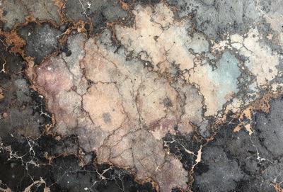 The primary subject of the image is a close-up of a rock wall with a mottled texture. The setting is a rocky surface, and the visual style appears to be a combination of a photo and digital art. The dominant colors are shades of brown and black, creating a moody and natural atmosphere.