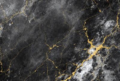 The primary subject of the image is a black and gold marble wall. The setting is a dark room with a black and gold marble wall as the main focus. The visual style is a combination of a photo and digital art, creating a unique and intricate pattern. The colors and mood of the image are predominantly dark, with the gold and black colors adding a sense of luxury and sophistication to the scene.