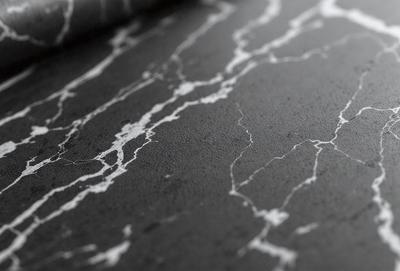 The primary subject of the image is a marble-like surface with a pattern of white and black. The setting is a black background, which contrasts with the marble-like surface. The visual style is a close-up of the marble-like surface, showcasing its texture and pattern. The colors and mood of the image are predominantly black and white, giving it a classic and elegant appearance.