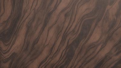 The primary subject of the image is a wooden surface with a unique and intricate pattern. The setting is a close-up view of the wooden surface, showcasing the details of the pattern. The visual style is a close-up of the wooden surface, which gives a sense of depth and texture. The colors and mood of the image are predominantly brown, giving it a warm and natural feel.