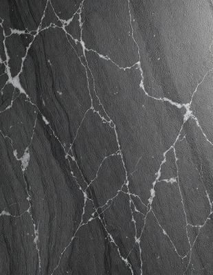 The primary subject of the image is a marble countertop with a black and white pattern. The setting is a kitchen, and the visual style is a photo. The countertop has a black and white marble pattern, and the overall atmosphere is elegant and sophisticated.