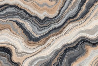 The image features a close-up of a marble-like stone with a unique pattern. The stone appears to be a mix of gray, brown, and black colors, creating a visually striking and textured surface. The close-up view of the stone emphasizes its intricate and natural design, making it an interesting focal point in the image.
