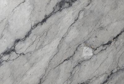 The primary subject of the image is a marble wall with a pattern of black and white. The setting is a room with a marble floor. The visual style is a close-up of the marble wall, showcasing its texture and pattern. The colors and mood of the image are predominantly black and white, giving it a classic and elegant appearance.