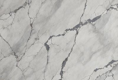 The primary subject of the image is a marble wall with a cracked and rough texture. The setting is a room with a white marble surface. The visual style is a close-up of the marble wall, showcasing its unique texture and appearance. The colors and mood of the image are predominantly white, giving it a clean and elegant appearance.