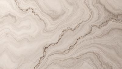 The primary subject of the image is a marble countertop with a unique, swirled pattern. The setting is a kitchen or bathroom, as the countertop is a prominent feature in the space. The visual style is a close-up of the marble countertop, showcasing its intricate design. The colors and mood of the image are predominantly neutral, with the marble countertop being the main focus and source of visual interest.