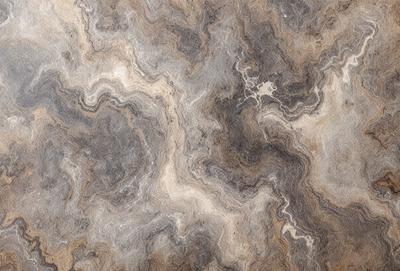 The primary subject of the image is a marble-like surface with a pattern of swirls and curves. The setting is a room with a stone-like floor, and the visual style appears to be a combination of a photo and a digital art or illustration. The colors and mood of the image are predominantly brown and gray, giving it a natural and earthy feel.