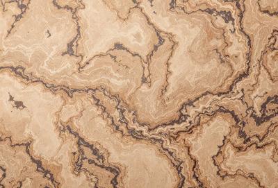 The primary subject of the image is a close-up of a wooden surface with a patterned design. The setting is a room with a wooden floor, and the visual style appears to be a combination of a photo and a digital art or illustration. The colors and mood of the image are warm and inviting, with the wooden surface and patterned design creating a cozy and comfortable atmosphere.
