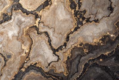 The primary subject of the image is a close-up of a marble surface with a pattern of gold and brown colors. The setting is a stone countertop, and the visual style is a photo. The dominant colors are gold and brown, creating a warm and natural atmosphere.