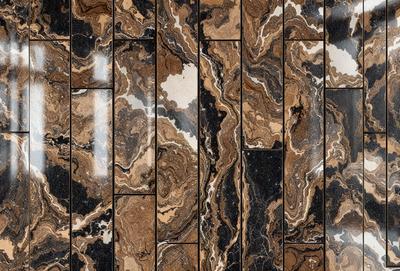 The primary subject of the image is a marble tile wall with a brown and black color scheme. The setting is a bathroom, and the visual style is a close-up of the tile wall. The colors and mood of the image are warm and earthy, creating a sense of luxury and sophistication.