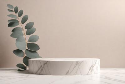 The primary subject of the image is a white marble table with a round top. The table is placed on a white marble countertop, which serves as the setting. The visual style of the image is a photo, capturing the details of the marble table and countertop. The colors and mood of the image are predominantly white, giving it a clean and elegant appearance.