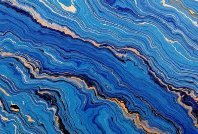The primary subject of the image is a blue and gold swirling pattern, which appears to be a piece of art or a decorative item. The setting is a blue background, which complements the vibrant colors of the pattern. The visual style is a combination of artistic and digital elements, creating a unique and eye-catching design. The dominant colors are blue and gold, with the blue background providing a calming and soothing atmosphere.