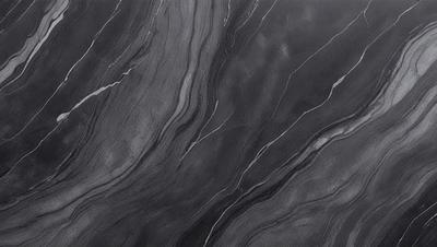 The primary subject of the image is a close-up of a marble countertop. The setting is a kitchen, with the countertop being the main focus of the scene. The visual style is a photo, capturing the intricate details of the marble surface. The colors and mood of the image are predominantly dark, with the marble countertop being the main source of light and contrast.