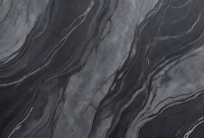 The primary subject of the image is a close-up of a marble surface, showcasing its intricate patterns and textures. The setting is a dark room, which contrasts with the light reflecting off the marble surface. The visual style is a close-up, emphasizing the details of the marble. The colors and mood of the image are predominantly dark, with the marble surface providing a sense of elegance and sophistication.